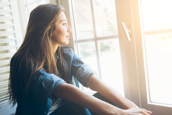 Woman looking out window