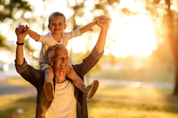 Grandfather with grandson on his shoulders